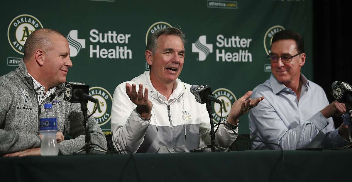 Oakland Athletics' Executive VP of Baseball Operations Billy Beane, center, gestures beside General Manager David Forst, left, and Manager Bob Melvin during a media conference Friday, Oct. 5, 2018, in San Francisco. After a 97-65 regular season, Oakland lost the wild-card game 7-2 to New York on Wednesday night at Yankee Stadium. (AP Photo/Ben Margot)