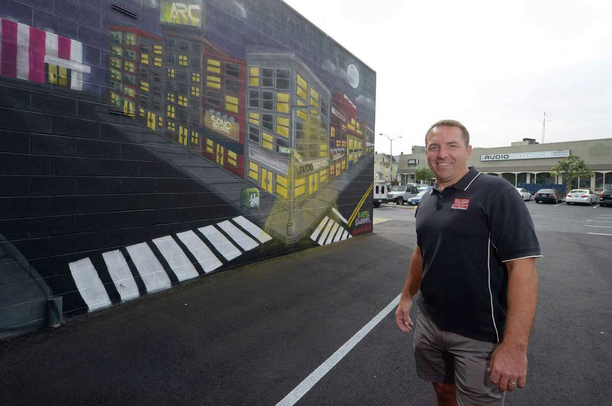 Realty businessman Jason Milligan had a mural painted on the side of one of his Isaacs Street buildings by the artist known as Action Thursday, October 4, 2018, in Norwalk, Conn.