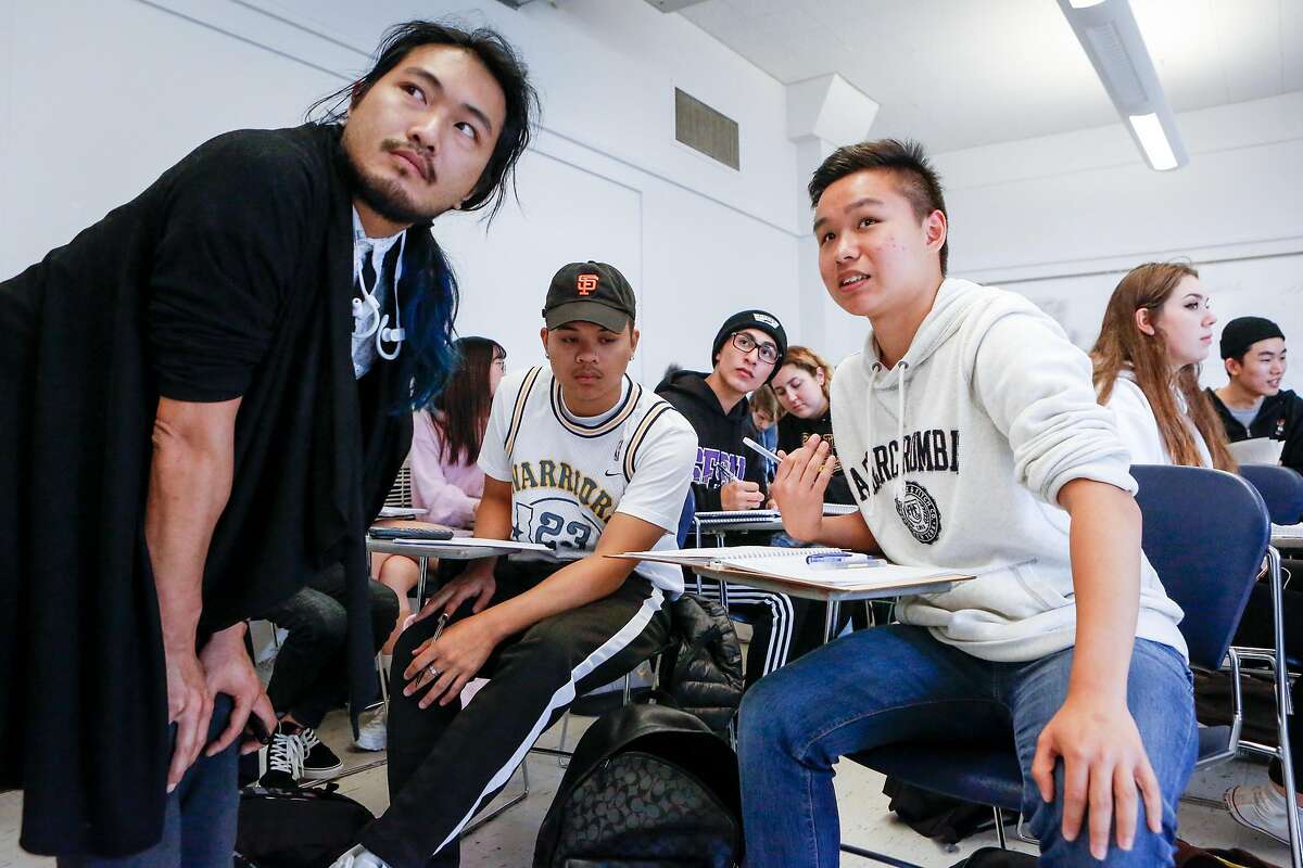 Timmy Chan (left) goes over an equation with students Joseph Imbat (center left) and Ryan Tsai during a Business Calculus class at SFSU on Monday, September 17, 2018 in San Francisco, Calif.