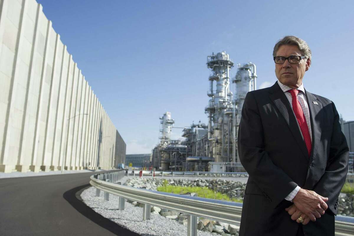 Secretary of Energy Rick Perry stands with the main cyrogenic heat exchange behind him as he speaks with reporters at Dominion Engery's Cove Point LNG liquefaction Project facility in Lusby, Md., Thursday, July 26, 2018. The completion of the facilities export expansion project makes it just the second LNG export facility in the U.S. (AP Photo/Cliff Owen)