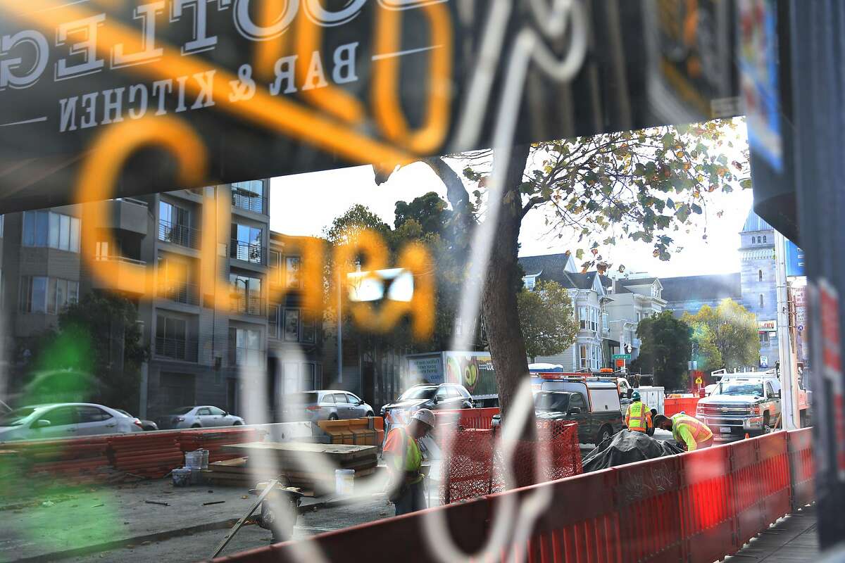 Construction work on Van Ness Avenue is reflected in a window at Bootleg Bar and Kitchen on Thursday, October 4, 2018 in San Francisco, Calif.