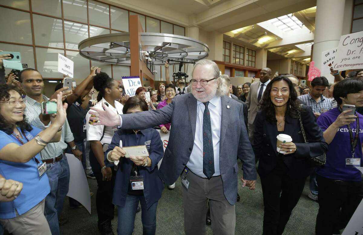 Jim Allison and his wife, Pam Sharma, walk through a procession at MD Anderson Cancer Center Friday, Oct. 5, 2018, in Houston as part of a celebration of his receiving the Nobel Prize earlier this week.