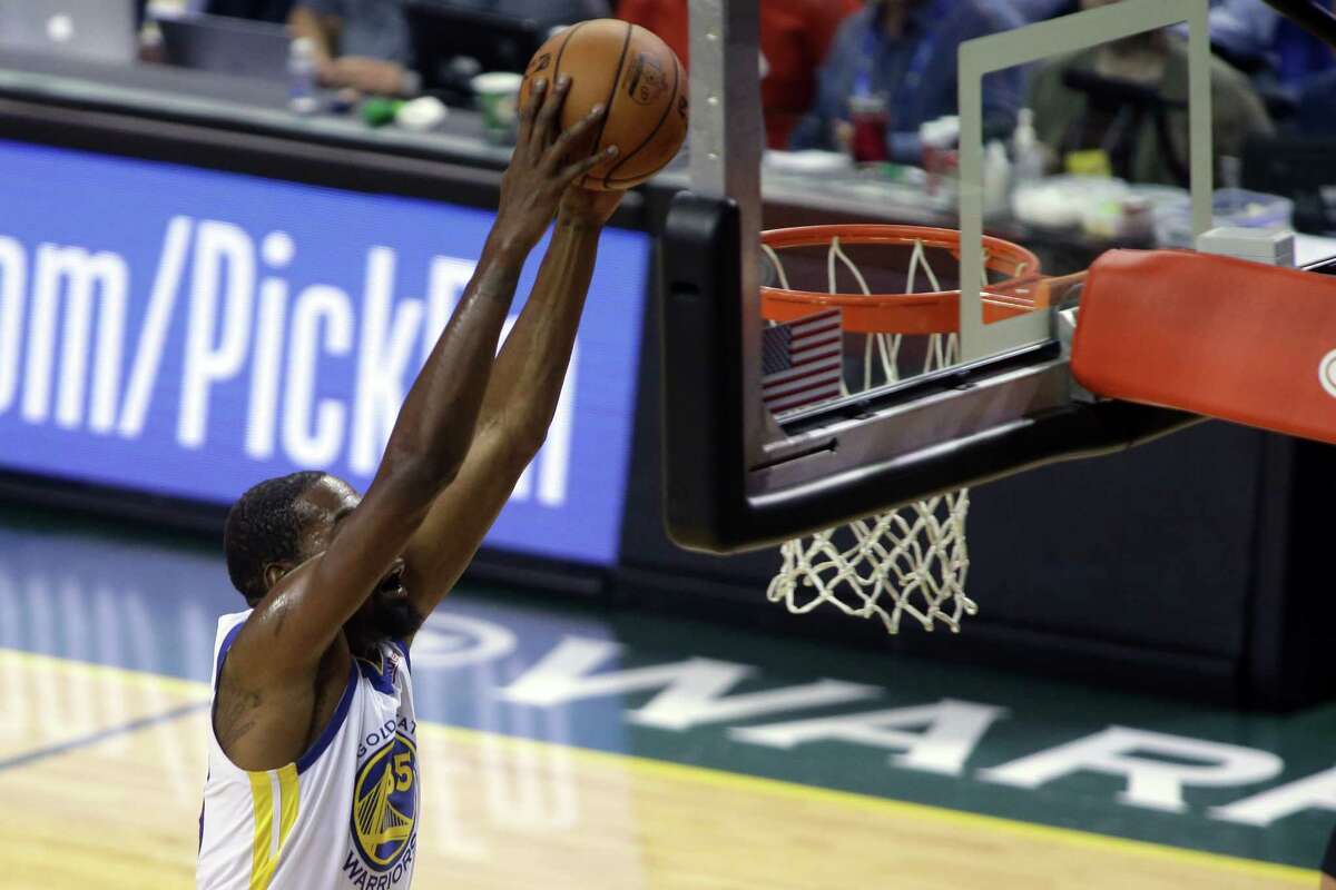 Golden State forward Kevin Durant scores during the Warriors' NBA preseason game against the Sacramento Kings at KeyArena, Friday, Oct. 5, 2018. The Warriors won 122 to 94.