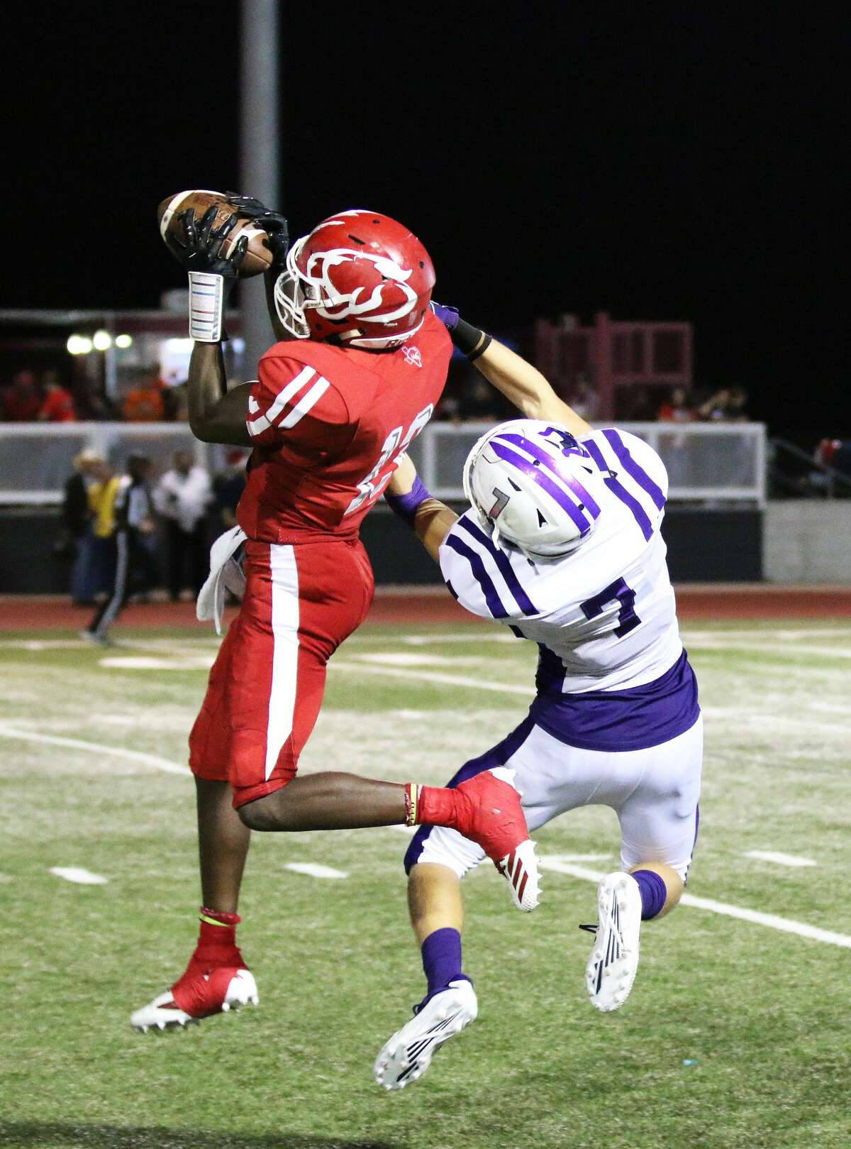 Crosby senior wide receiver Marquise Doucette goes up for a  Jaiden Howard pass while Dayton junior Brice Chimene tries to defend. The Cougars eventually scored a few plays later to extend their lead over the Broncos.