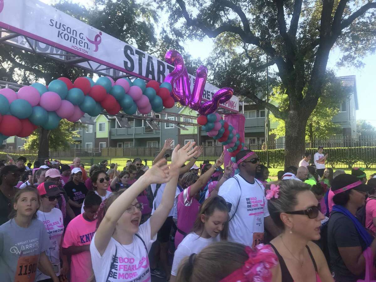 Participants of the 28th annual Susan G. Komen Race for the Cure make their way past the starting line on Allen Parkway.