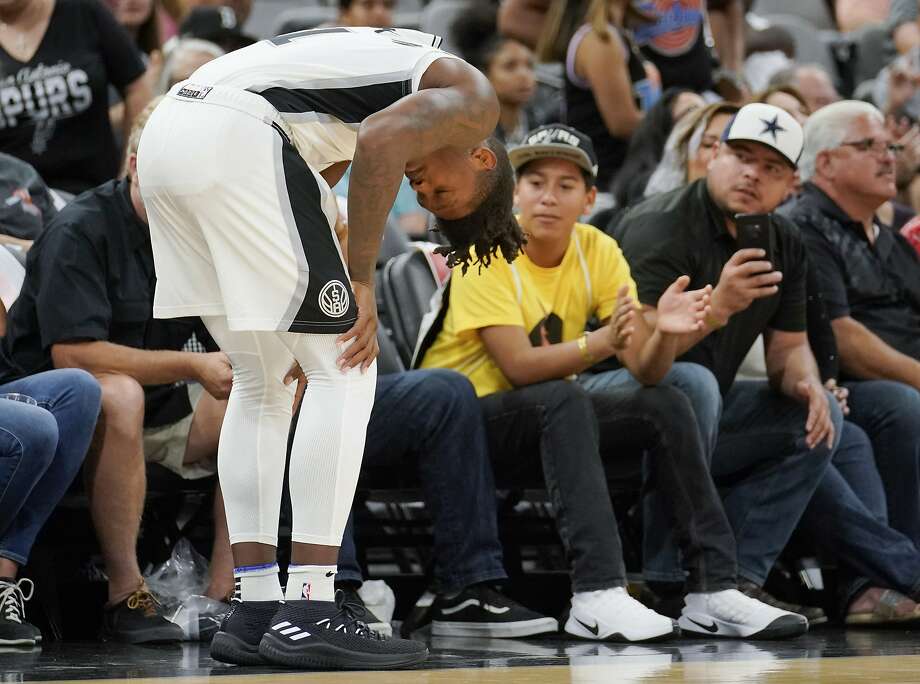 San Antonio Spurs' Lonnie Walker IV pauses on the court after injuring his leg during the second half of an NBA preseason basketball game against the Detroit Pistons, Friday, Oct. 5, 2018, in San Antonio. San Antonio won 117-93. (AP Photo/Darren Abate) Photo: Darren Abate, Associated Press