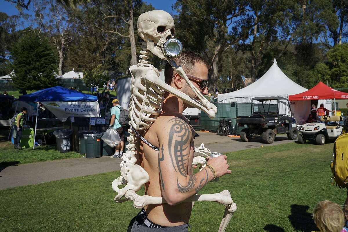 Steven Spurrell, 30, wears a skeleton holding a beer can during the Hardly Strictly Bluegrass music festival at Golden Gate Park in San Francisco, Calif. on Saturday, October 6, 2018.