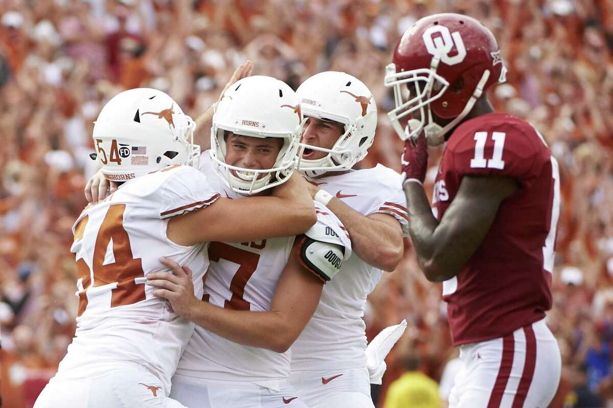Texas kicker Cameron Dicker (17) celebrates with teammates after kicking the game-winning field goal in the closing seconds of the second half of an NCAA college football game against Oklahoma at the Cotton Bowl, Saturday, Oct. 6, 2018, in Dallas. Texas won 48-45. (AP Photo/Cooper Neill)