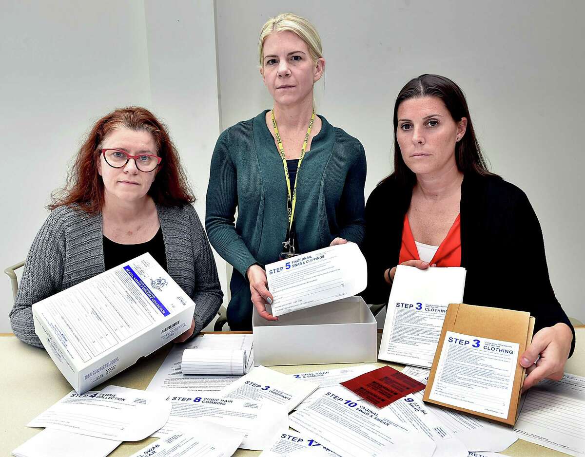 Laura Cordes, director of the CT Alliance, Cheryl Carreiro, laboratory quality assurance manager and Kristin Sasinouski, deputy director of forensic biology and DNA display the contents of the State of Connecticut Sexual Assault Evidence Collection Kit at the State Crime Lab in Meriden Wednesday, Sept. 26.