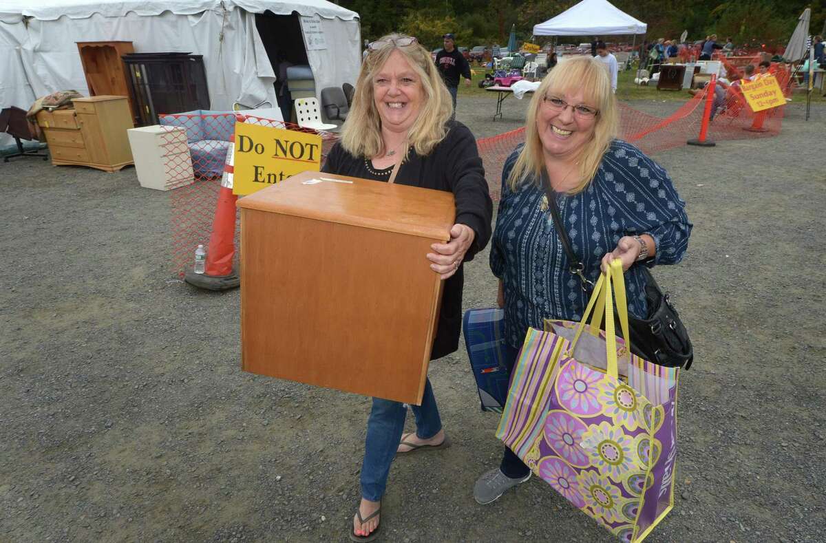 Chris Zullo and Patty Goico of Norwalk shop for items at the twice-yearly Minks to Sinks sale Saturday, October 6, 2018, at Wilton High School in Wilton, Conn. The sale will benefit the Family and Children?’s Agency in Norwalk, Conn.