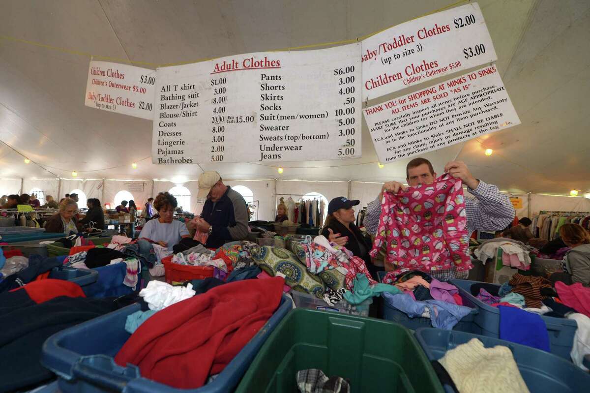Shoppers look through clothing during the twice-yearly Minks to Sinks sale Saturday, October 6, 2018, at Wilton High School in Wilton, Conn. The sale will benefit the Family and Children?’s Agency in Norwalk, Conn.