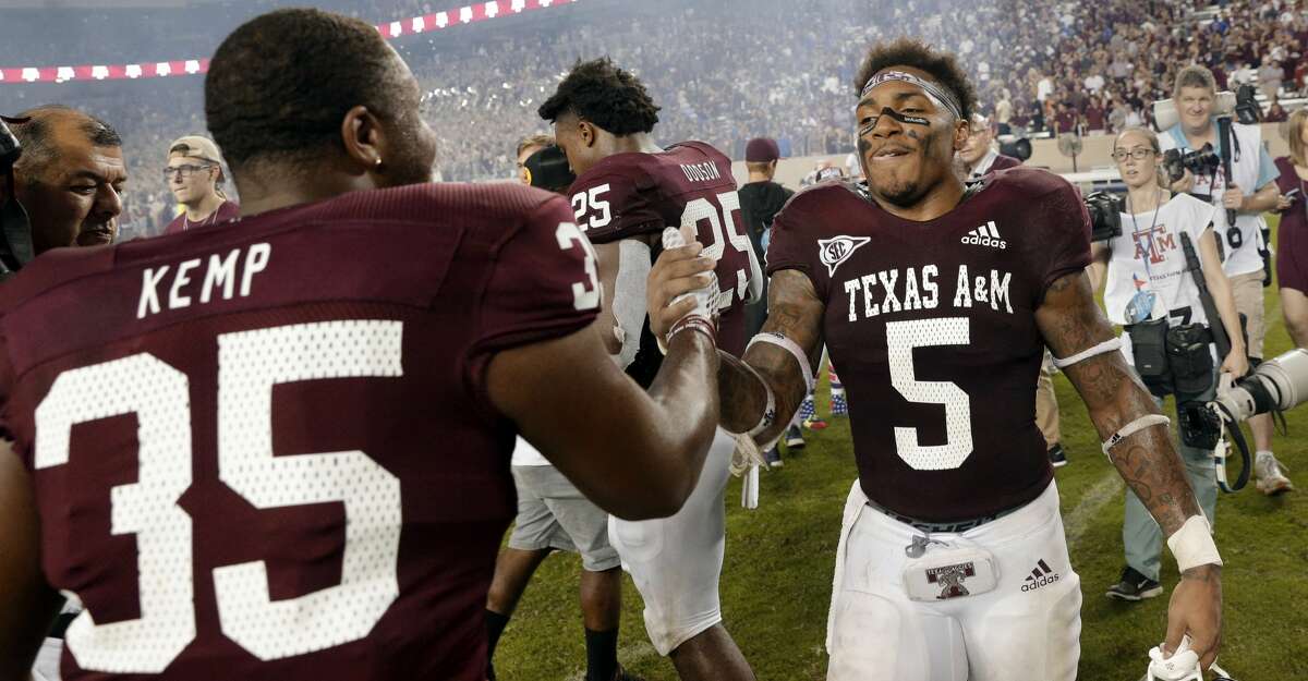 Texas A&M fullback Javonte Kemp (35) shakes hands with running back Trayveon Williams (5) at midfield after winning an NCAA college football game in overtime on Williams' score Saturday, Oct. 6, 2018, in College Station, Texas. (AP Photo/Michael Wyke)