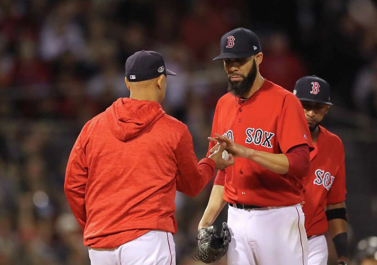 Alex Cora of the Red Sox takes the ball from starting pitcher David Price during the second inning of Game 2 of the ALDS Saturday against the Yankees. (Photo by Elsa/Getty Images)