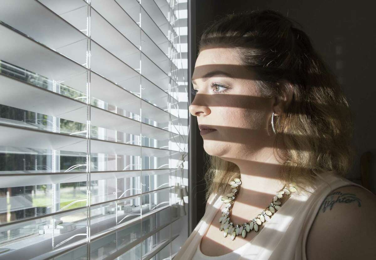 Former Air Force recruit Virginia Messick looks out the front window of her home in Baker, Florida on Friday, October 5, 2018.