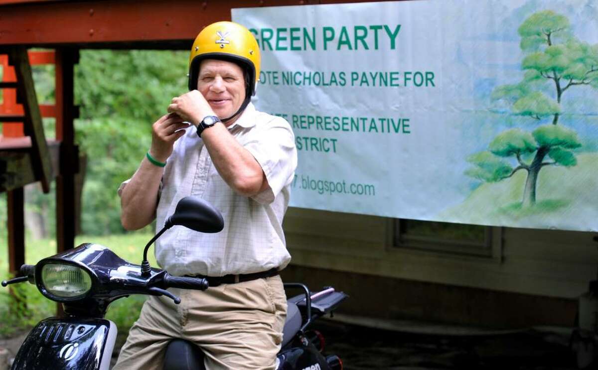 Nicholas Payne, of New Milford, is the Green Party candidate for state representative in the 67th district.Here he sits on the all-electric scooter he rides on his door-to-door campaign on Tuesday, July 13, 2010.