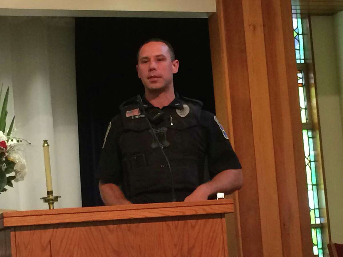 Ansonia Police Officer Brendon Nelson thanks the First Baptist Church for organizing Main Street restaurants into a Tip-A-Cop program to raise money for police protective gear.