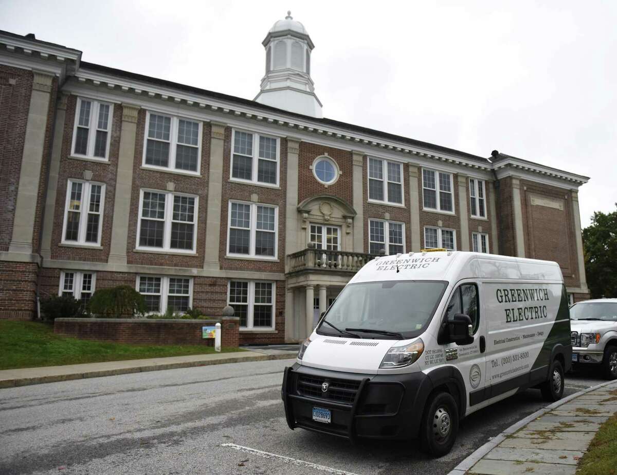 Maintenance vans are parked outside Cos Cob School in the Cos Cob section of Greenwich, Conn. Monday, Oct. 8, 2018. The school was closed Monday and will be closed again Tuesday for "ongoing assessment of damage as a result of a water leak." The open house scheduled at Cos Cob School for Thursday, Oct. 11, is also canceled and will be rescheduled for a later date.