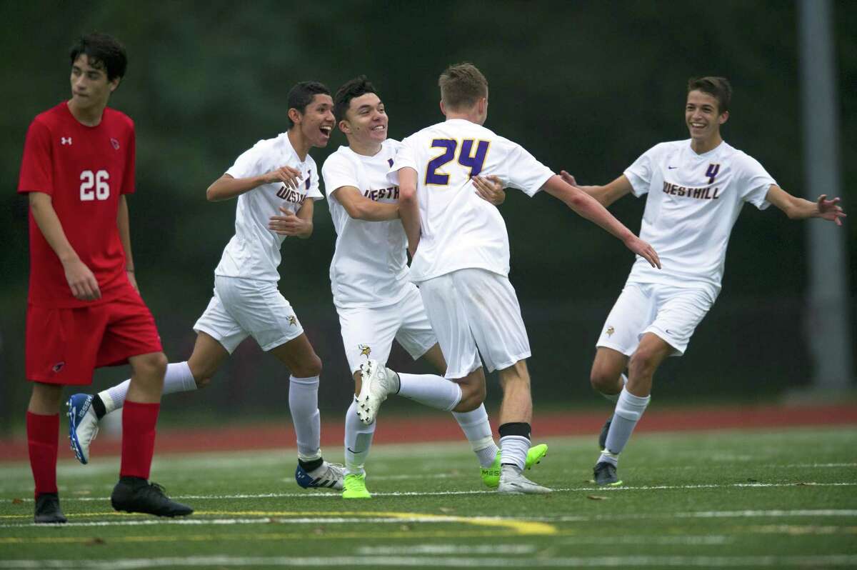 Westhill players, from left, David Torres, Jorge Betancour, Eric Zagaja and Christopher Matrullo joyously celebrate Zagaja’s bicycle-kick goal against Greenwich at Cardinal Stadium in Greenwich on Monday. Greenwich and Westhill tied 2-2.