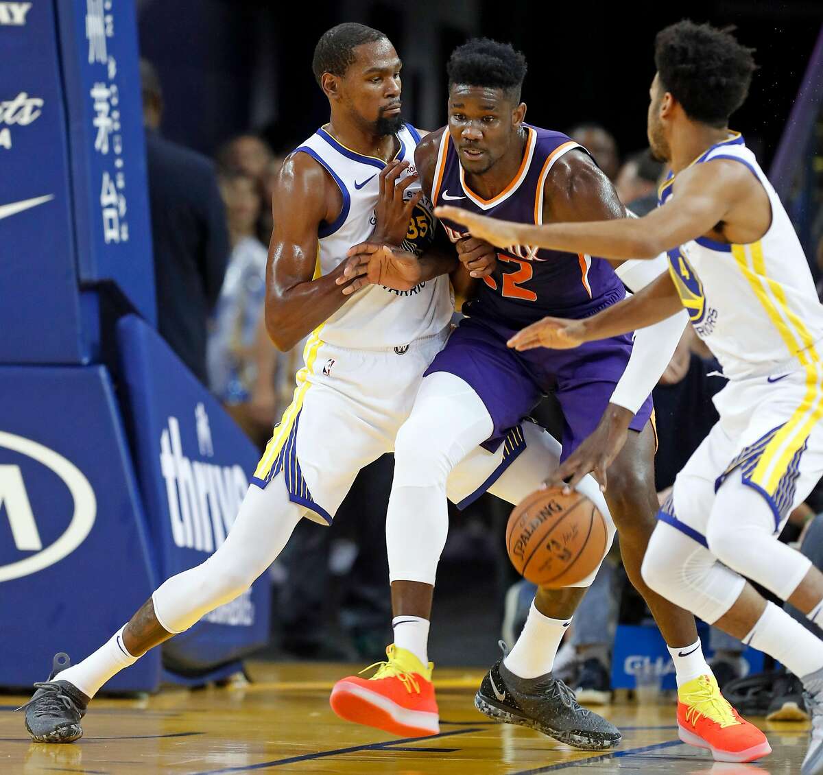 Golden State Warriors' Kevin Durant guards Phoenix Suns' Deandre Ayton in 2nd quarter during NBA preseason game at Oracle Arena in Oakland, Calif. on Monday, October 8, 2018.