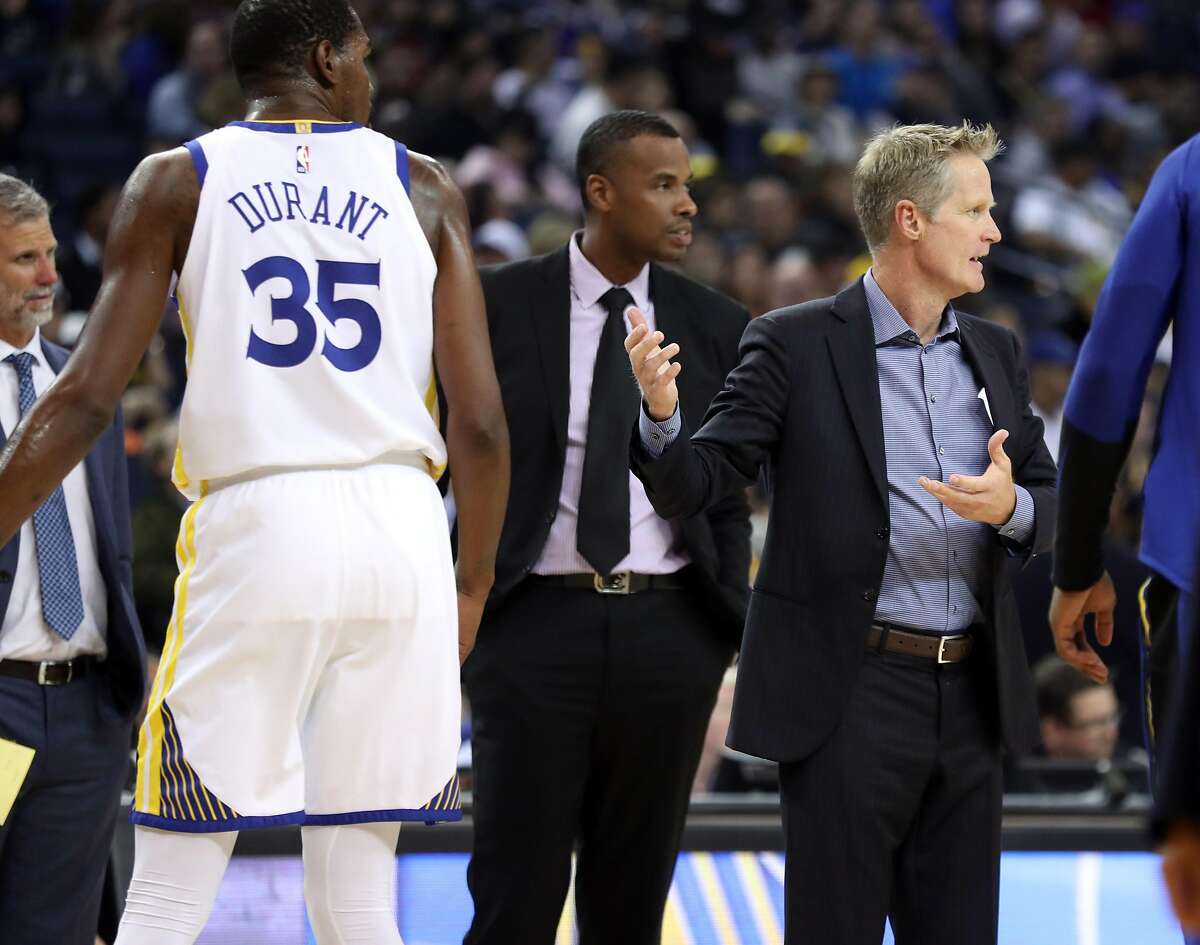 Golden State Warriors' head coach Steve Kerr disputes a foul call on Kevin Durant during 1st quarter against Phoenix Suns during NBA preseason game at Oracle Arena in Oakland, Calif. on Monday, October 8, 2018.