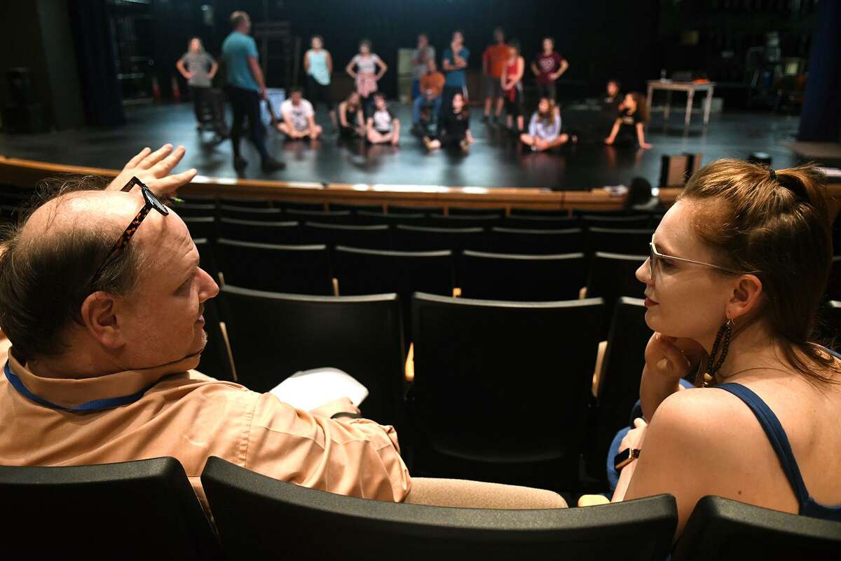 Director Michael Montgomery, of Cypress, left, and Courtney Berry, 26, of Spring, who is playing the part of the "Ghost of Christmas Past" in the upcoming Stageworks Theatre production of "A Christmas Carol", chat off stage during a rehearsal at The Lone Star College - Cy-Fair Performing Arts Center on Sept. 26, 2018.