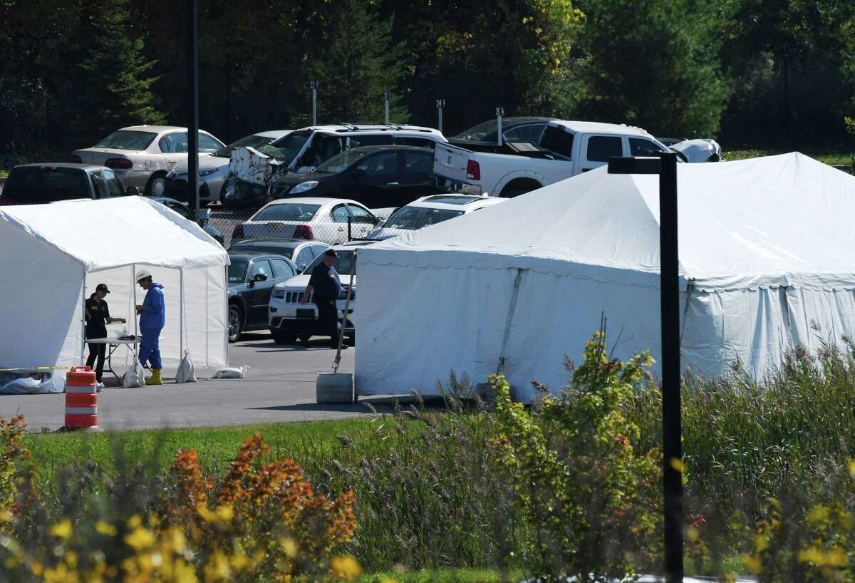 National Transportation Safety Board investigators and state police are examining the limousine that took the lives of 20 in Saturday's fatal crash in Schoharie County, as they search for answers under the cover of a tent, right, at State Police Troop G Headquarters on Tuesday, Oct. 9, 2018, in Latham, N.Y. (Will Waldron/Times Union)