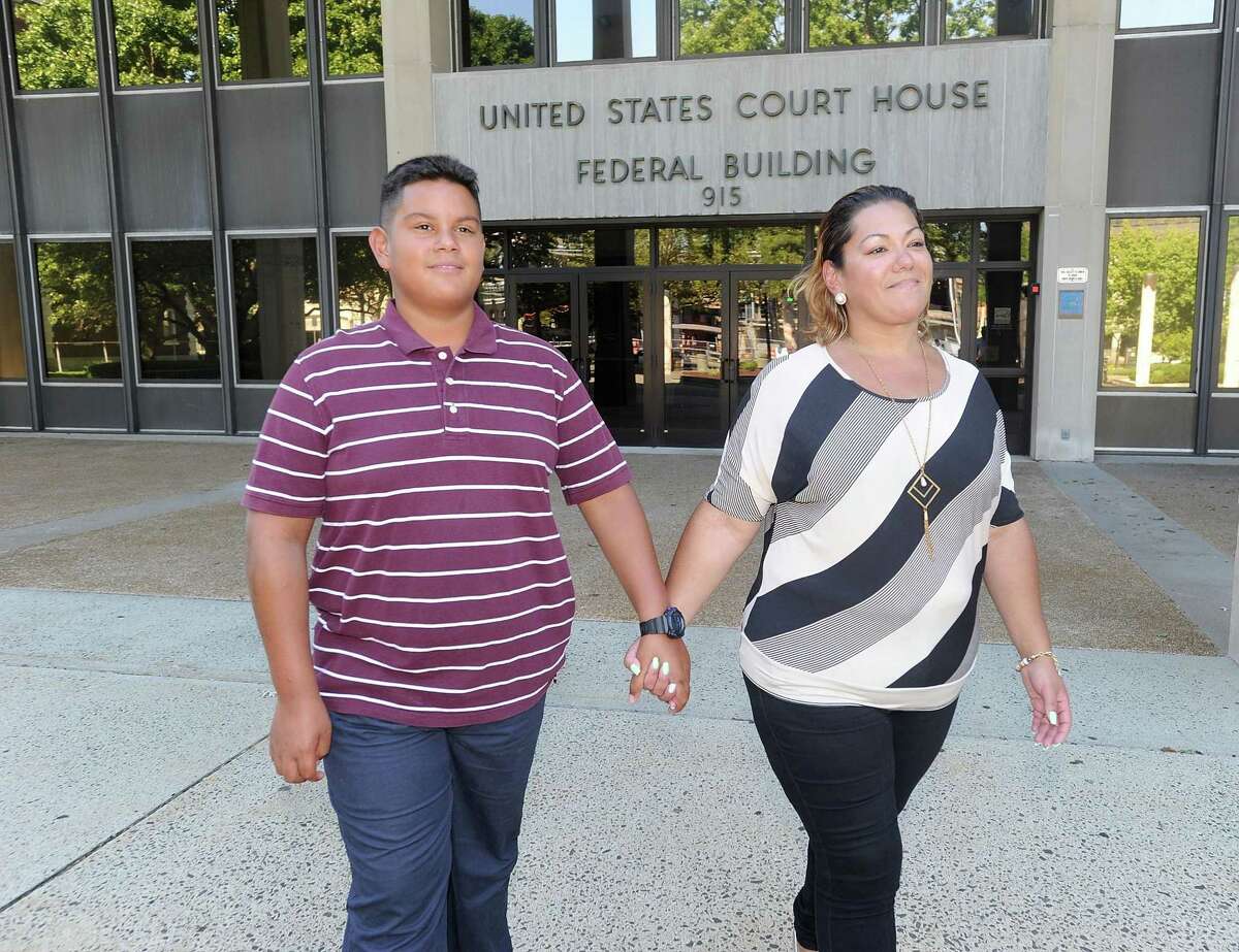 Jose Martinez and his mother, Jessica Martinez, lead plaintiff in Martinez vs. Malloy, pose for a photo outside U.S. District Court in Bridgeport on Aug. 24.