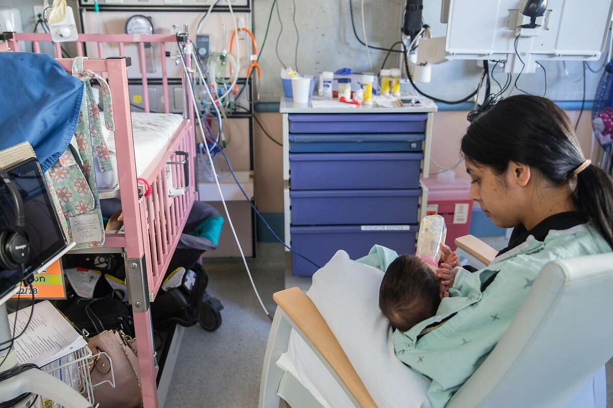 Jessica Cortez feeds her daughter, 4-month-old Janelle Cayton, while inside the Neonatal Intensive Care Unit of UCSF Benioff Children's Hospital in Oakland, Calif. Wednesday, Oct. 3, 2018.