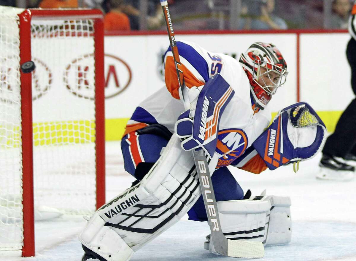 Islanders’ goalie Jeremy Smith leans away from the net as the puck passes by the pipe during the third period of a preseason hockey game against the Philadelphia Flyers on Sept, 17.