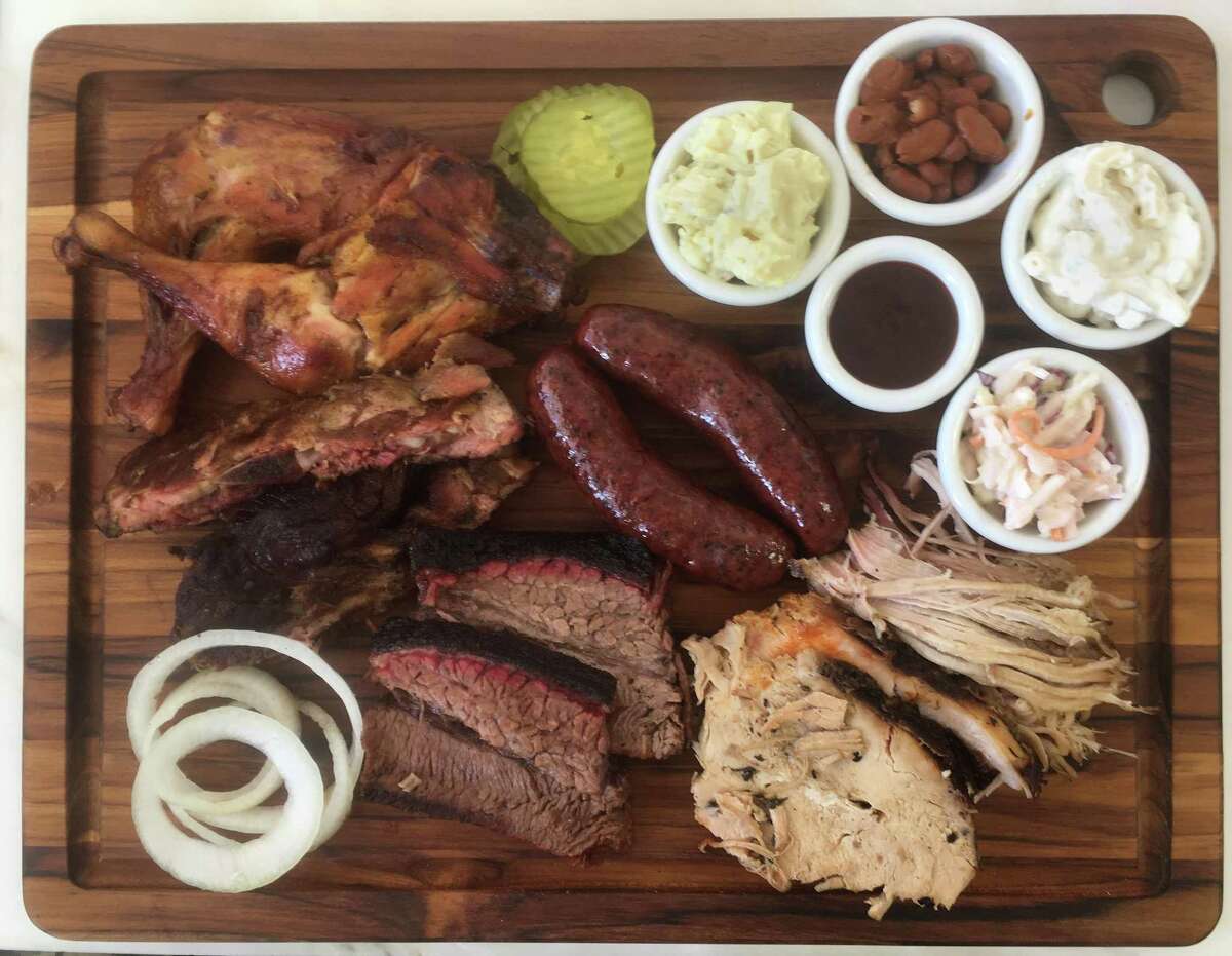 The BBQ Life board (from top left) includes: chicken quarters, sausage, potato salad, ranch beans, macaroni salad, coleslaw, pulled pork, turkey, brisket and ribs.
