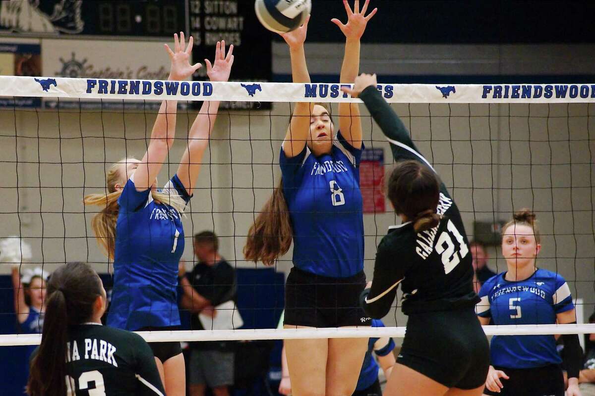 Friendswood's Tori Weatherley (1) and Nicole Scott (8) go high to block a shot by Galena Park's Alexa Quiroga (21) Tuesday at Friendswood High School.