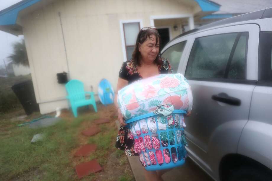 Kathy Eaton takes what she can from her home as she tries to get out of the way of the storm as the outerbands of hurricane Michael arrive on October 10, 2018 in Panama City Beach, Florida. The hurricane is forecast to hit the Florida Panhandle at a possible category 4 storm. Photo: Joe Raedle/Getty Images