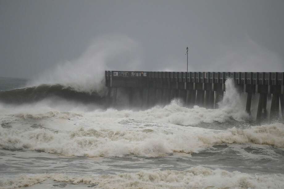 Waves crash along a pier as the outerbands of hurricane Michael arrive on October 10, 2018 in Panama City Beach, Florida. The hurricane is forecast to hit the Florida Panhandle at a possible category 4 storm. Photo: Joe Raedle/Getty Images