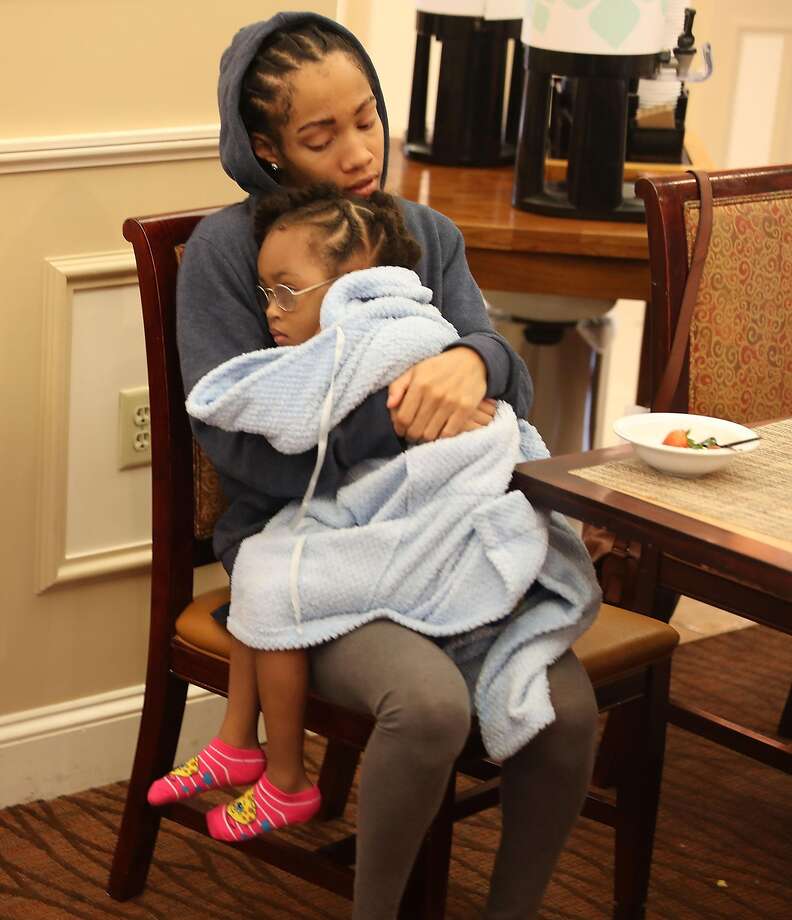 Neko Blaine holds Alaina Blaine, 4, as they sit in the lobby of the Hilton Gardens Inn after leaving their home for a safer place as the outer bands of hurricane Michael arrive on October 10, 2018 in Panama City, Florida. The hurricane is forecast to hit the Florida Panhandle at a possible category 4 storm. (Photo by Joe Raedle/Getty Images) Photo: Joe Raedle, Getty Images