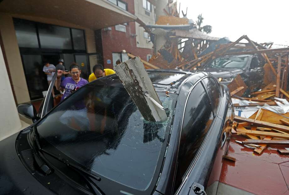 A woman checks on her vehicle as Hurricane Michael passes through, after the hotel canopy had just collapsed, in Panama City Beach, Fla., Wednesday, Oct. 10, 2018. (AP Photo/Gerald Herbert) Photo: Gerald Herbert, Associated Press