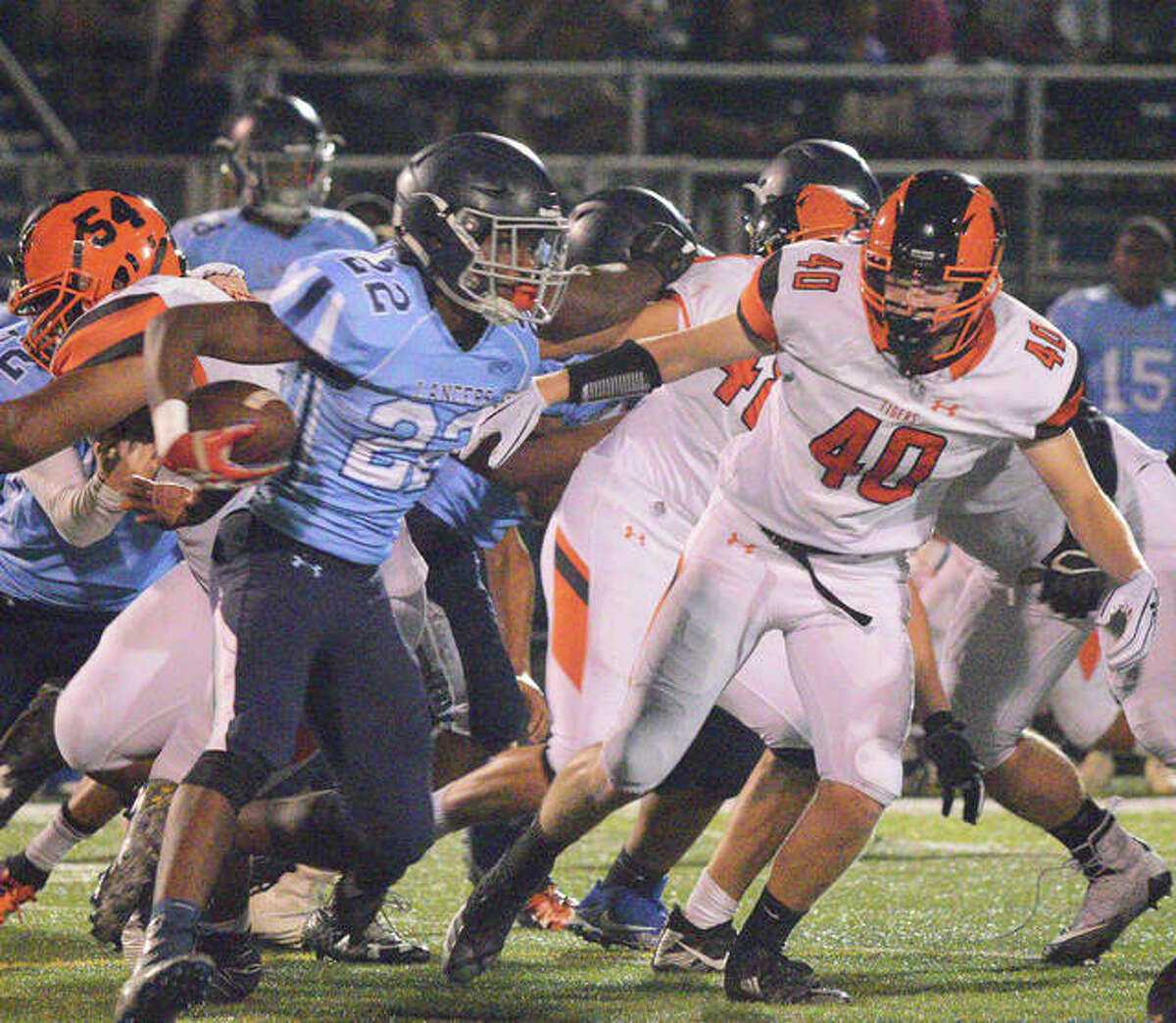 Edwardsville’s Adam Foster chases down the Belleville East running back during last Friday’s game in Belleville.