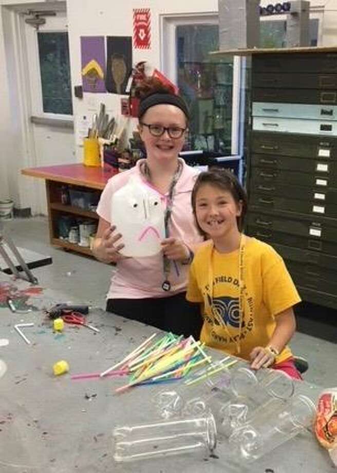 Sixth-grade Country School students Michaela Troy and Rosie Liu construct a scarecrow for the Madison Chamber of Commerce's Scarecrows Invade Madison contest." Photo: Louise Jackson / Contributed Photo