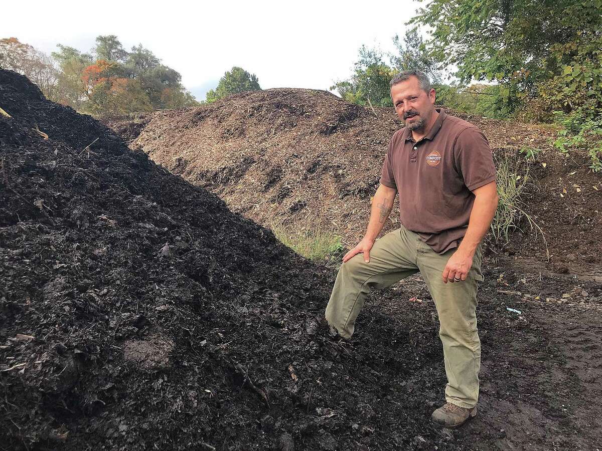 Jeff Demers, owner of New England Compost in Danbury, Conn., stands near a pile of compost made from leaves and other organic matter on Wednesday, Oct. 10, 2018. Several landscaping companies bring their leaves to New England Compost following fall lawn cleanups.