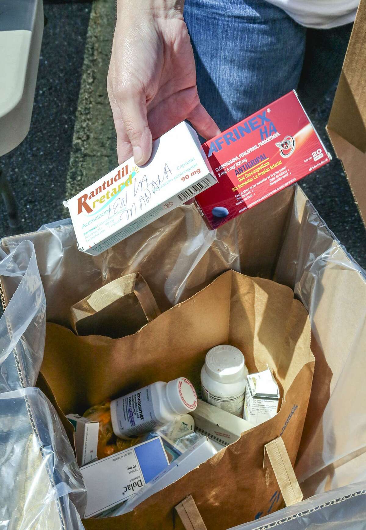 Prescription medication collected by the U.S. Drug Enforcement Administration is seen in a container before being sealed away for proper disposal, Saturday morning during National Drug Take Back Day.