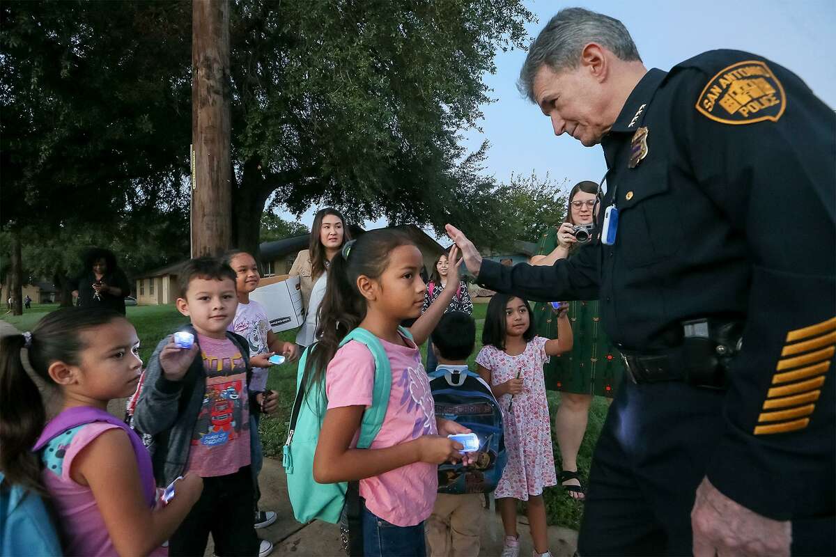 San Antonio Police Chief William McManus high-fives children waiting to go to school in a "Walking School Bus" organized by Safe Kids San Antonio on Wednesday, Oct. 10, 2018. Partners and volunteers joined the Walking School Bus at Cassiano homes and greeted students arriving at Sarah King Elementary.