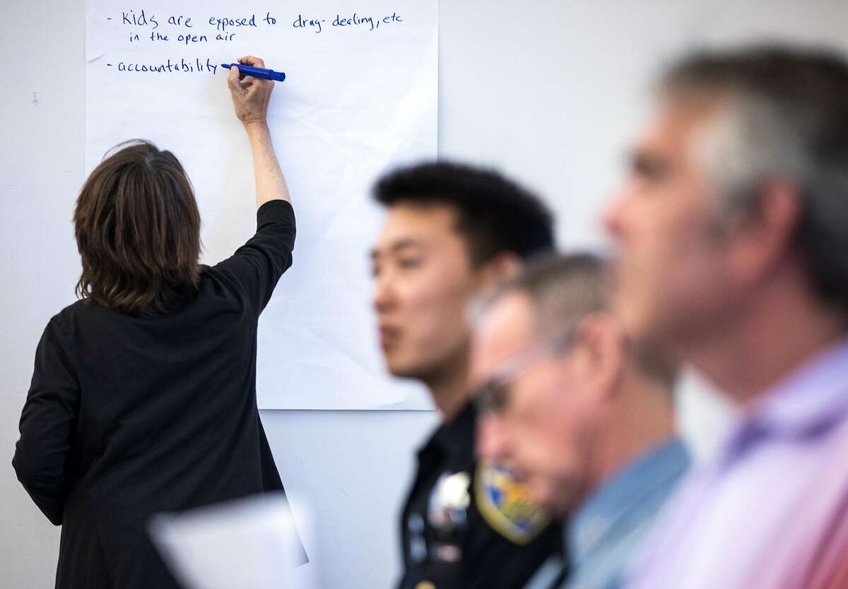 A secretary takes notes as residents share their concerns during a community meeting surrounding RV and commercial vehicle parking issues in the Portola neighborhood of San Francisco, Calif. Tuesday, Oct. 9, 2018.