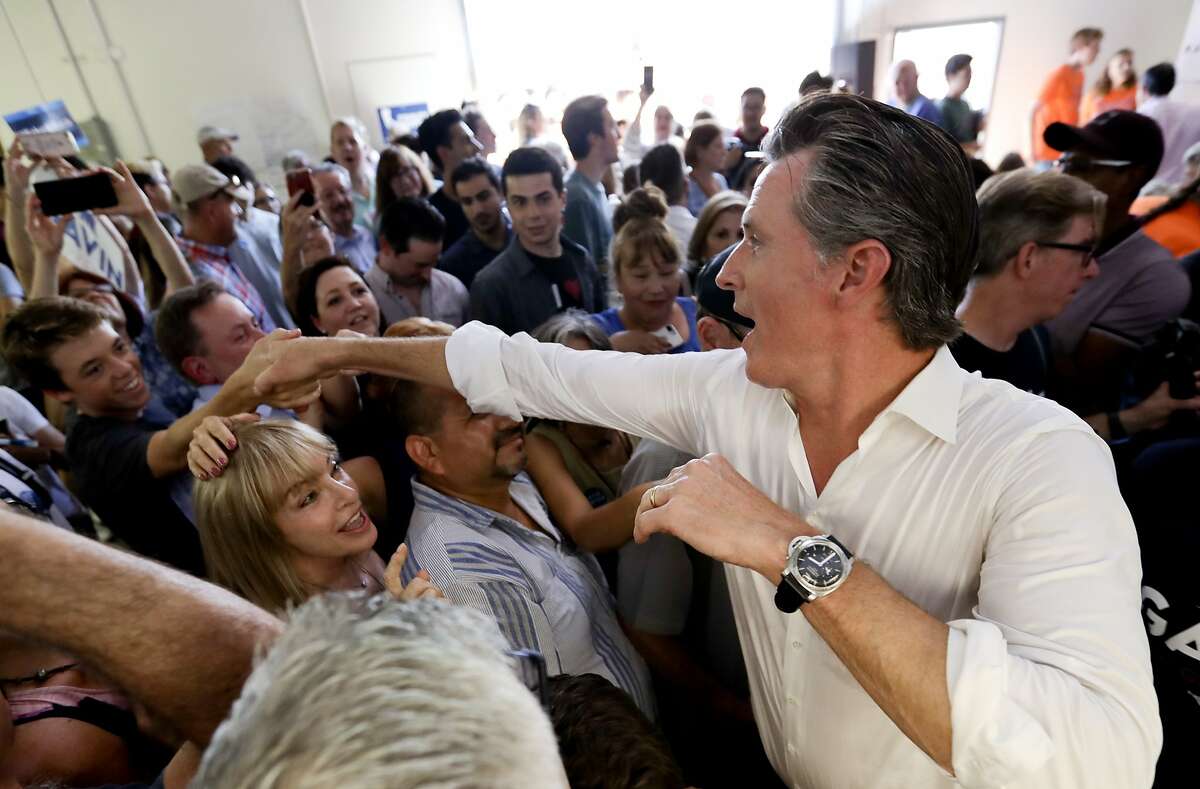 FILE - In this Sept. 15, 2018, file photo, California gubernatorial candidate, Lt. Gov. Gavin Newsom, a Democrat, greets supporters after a campaign stop in Tustin, Calif. California's race for governor pits Newsom, a Democrat and former San Francisco mayor, against Republican businessman John Cox. (AP Photo/Chris Carlson, File)
