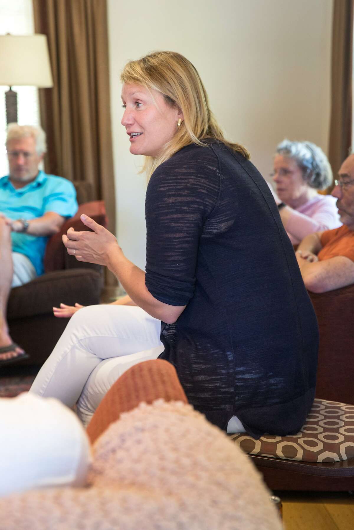 Buffy Wicks, a candidate for the 15th State Assembly district, talks with supporters during a house party hosted by Carmen Murray, leader in the local Organizing For Action group. On Sunday, October 7, 2018 in Oakland Calif.
