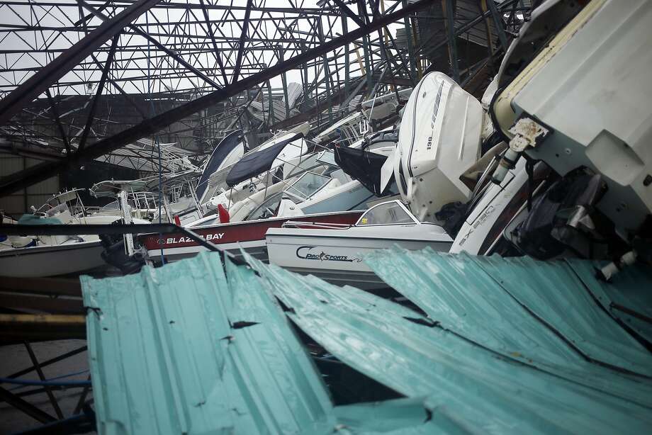 Boats sit in a storage warehouse damaged from Hurricane Michael at Treasure Island Marina in Panama City Beach, Florida, U.S., on Wednesday, Oct. 10, 2018. Investors are tracking�Hurricane�Michael�as it barrels toward Florida with winds strengthening to 145 miles per hour, posing potential consequences for companies in the building, hospital, insurance and energy industries, among others. The Category 4 storm, poised to be the strongest to hit the continental U.S. since 2004, is�expected�to make landfall Wednesday and could cause $16 billion in damage. Photographer: Luke Sharrett/Bloomberg Photo: Luke Sharrett, Bloomberg