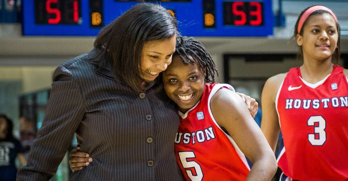 Houston guard Porsche Landry (5) celebrates with assistant coach Ravon Justice following a 53-51 victory over Rice in a college basketball game at Tudor Fieldhouse, Sunday, Feb. 10, 2013, in Houston. ( Smiley N. Pool / Houston Chronicle )