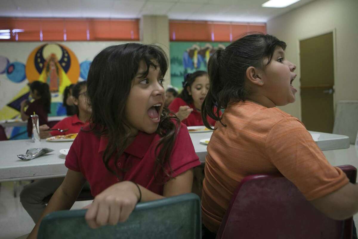 Araceli Pena, left, and Kayleen Salinas, both 9, both yell “Girl genuises!” as about 75 girls are called to attention by leaders Wednesday during the after-school program at West Side Girl Scout Leadership Center. The West Side Girl Scouts Leadership Center offers support to girls through programs to help them become future leaders.