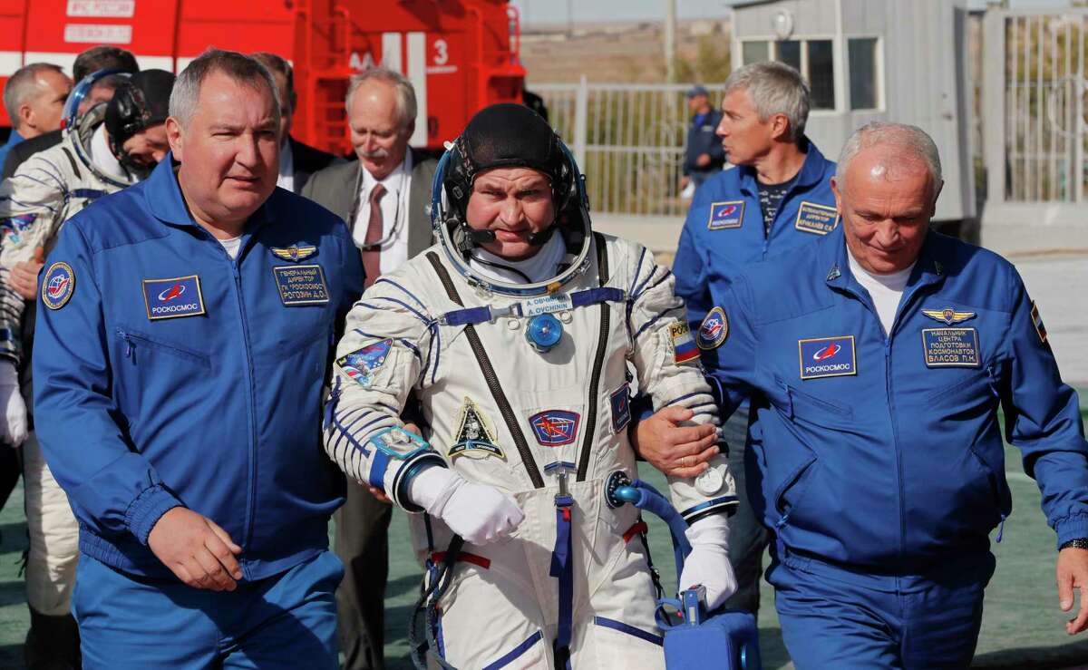 Director General of the Russia state corporation Roscosmos Dmitry Rogozin, right, accompanies Russian cosmonaut Alexey Ovchinin, crew members of the mission to the International Space Station, ISS, to the rocket prior the launch of Soyuz-FG rocket at the Russian leased Baikonur cosmodrome, Kazakhstan, Thursday, Oct. 11, 2018. (Yuri Kochetkov, Pool Photo via AP)