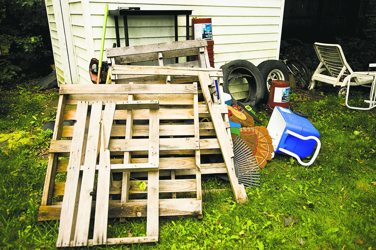 A bunch of wooden pallets sit in a pile in the backyard of Ari Parsons and Ryan Gerulski on the 1000 block of Elizabeth Street on Wednesday in Midland. The couple awoke around 4:30 a.m. on Friday when Ari’s 9-year-old daughter told them there was a man in her bedroom. The man then exited through the second-story window, jumped to the ground and fled. The pallets were stacked up against the house after the incident, leading Ari to believe the man climbed the pallets to enter the second-story window. (Katy Kildee/kkildee@mdn.net)