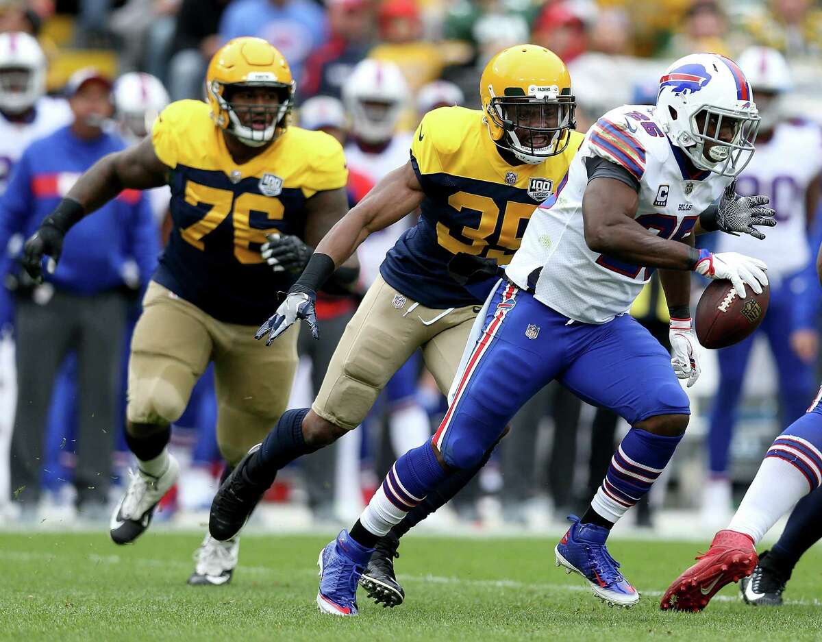 GREEN BAY, WI - SEPTEMBER 30: LeSean McCoy #25 of the Buffalo Bills runs away from Jermaine Whitehead #35 of the Green Bay Packers and Mike Daniels #76 during the first quarter of a game at Lambeau Field on September 30, 2018 in Green Bay, Wisconsin.