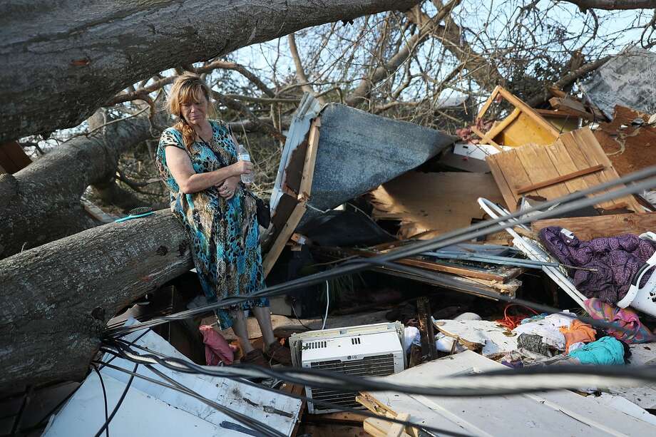 Kathy Coy stands among what is left of her home after Hurricane Michael destroyed it on October 11, 2018 in Panama City, Florida. She said she was in the home when it was blown apart and is thankful to be alive. The hurricane hit the Florida Panhandle as a category 4 storm. Photo: Joe Raedle/Getty Images